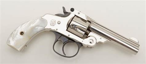 I can barely see part of patent date (JAN 29) on bottom edge of left panel. . Smith and wesson top break revolver grips